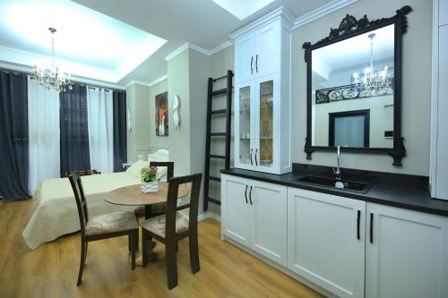 a dining room with a table and a mirror at Sea Pearl Apartments in Vlorë