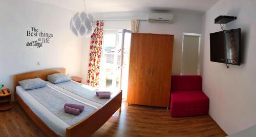 a bedroom with a bed and a tv and a chair at Villa Marijeta Hvar in Hvar