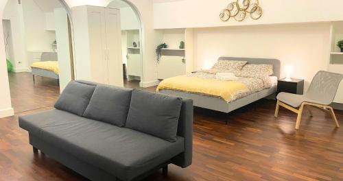 a bedroom with a bed and a couch at Antica Muraglia Apartments in Molfetta