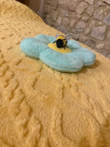a bee on a blue towel on a bed at Il Richiamo della Cascata in Papigno