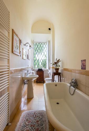 a large bathroom with a tub and a sink at Entire Private Floor in an 1800s Frescoed Villa with Historic Park - Villa Mastrangelo in Colli del Tronto