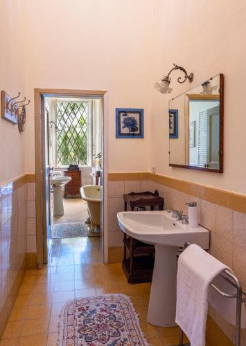 a bathroom with a sink and a mirror at Entire Private Floor in an 1800s Frescoed Villa with Historic Park - Villa Mastrangelo in Colli del Tronto