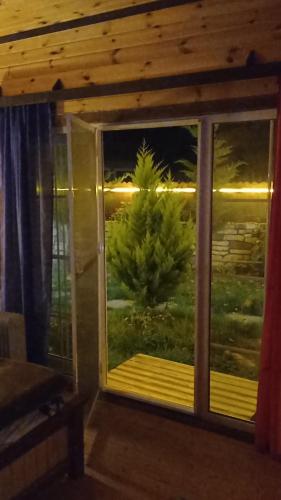 a room with a window with a view of a tree at Quba A-Frame near Lake & Forest in Quba