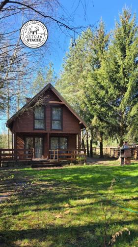 a house in the middle of a yard with trees at Ostoja Stacze in Stacze