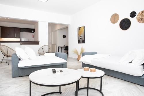 a living room with two couches and two tables at ChrisAri House in Zipárion