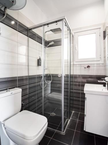 a bathroom with a shower and a toilet and a sink at Endless Blue Himara in Himare