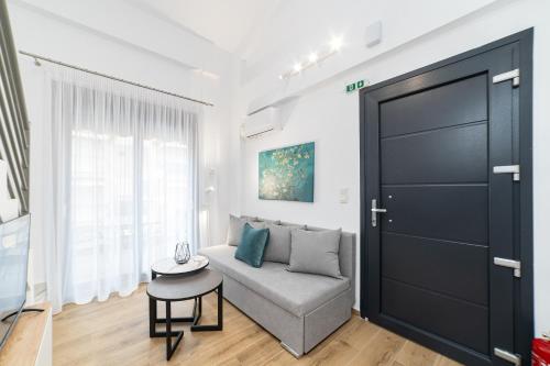a living room with a couch and a table at Erato Residential Complex in Ofrínion