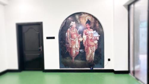 a painting of two men on the side of a wall at SummerSet in Dambulla