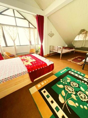 a bedroom with a bed and a large window at Nehal Royal Homestay in Kalimpong
