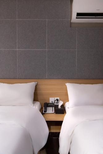 Ένα ή περισσότερα κρεβάτια σε δωμάτιο στο About Stay Seoul