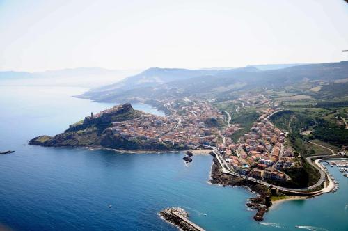 an aerial view of a small island in the water at Il Borgo BagaBaga - Exclusive Country Retreat in Castelsardo