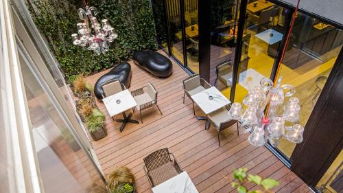 an overhead view of a patio with chairs and a chandelier at Campanile Rennes Centre - Gare in Rennes