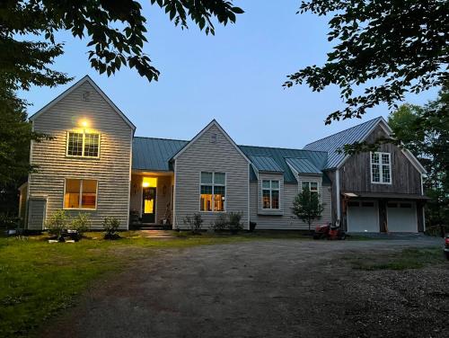 a large house with a driveway in front of it at Panoramic Mountain Views with Hot Tub in Jamaica