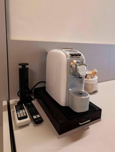 a mixer sitting on a counter next to a remote control at La Gioconda in Cascia