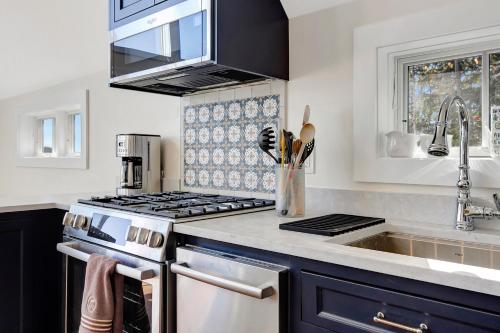 a kitchen with a stove and a sink at Panoramic Mountain Views with Hot Tub in Jamaica