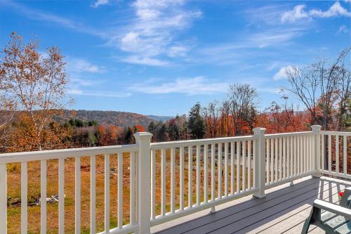a white railing on a deck with a view of the mountains at Panoramic Mountain Views with Hot Tub in Jamaica