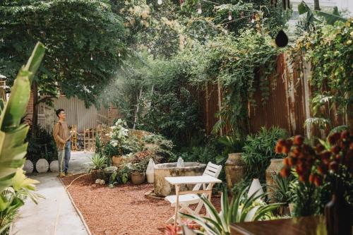 a man standing in a garden with plants at North House in Ấp Bình Trung