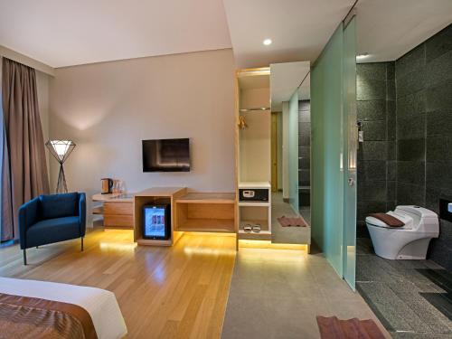Dieses Hotelzimmer verfügt über ein Bad mit einem WC und einer Dusche. in der Unterkunft Tama Boutique Hotel in Bandung