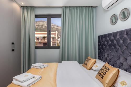 a bedroom with a large bed and a window at XIO Apartments in Bar