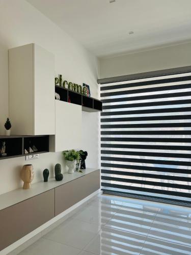 a living room with a large window with a blind at B&B Luxury La Fabbrica in Mercato San Severino