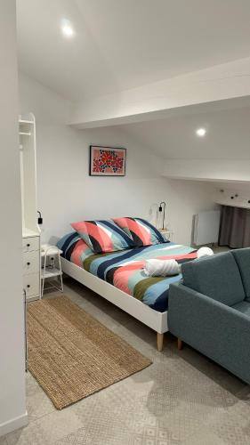 a bedroom with a large bed and a couch at Cozy studio with terrace and view Collobrières in Collobrières