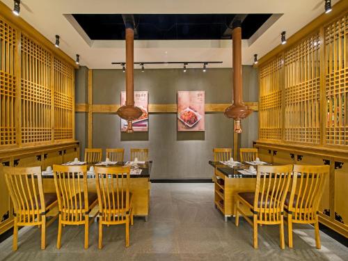 a dining room with a table and chairs at Tama Boutique Hotel in Bandung