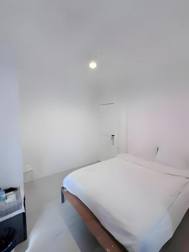 a white bed in a white room with at XX BAO Patong Beach Phuket - เบา ป่าตอง in Patong Beach