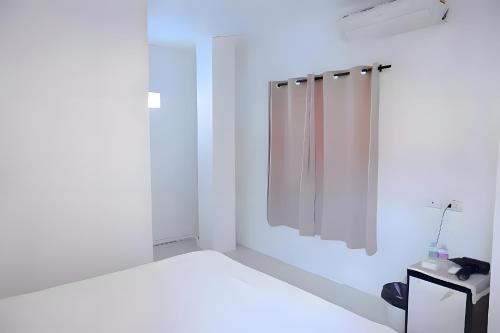 a white bathroom with a shower and a mirror at XX BAO Patong Beach Phuket - เบา ป่าตอง in Patong Beach