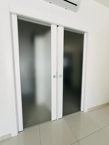 two sliding glass doors in a room with white walls at B&B Luxury La Fabbrica in Mercato San Severino
