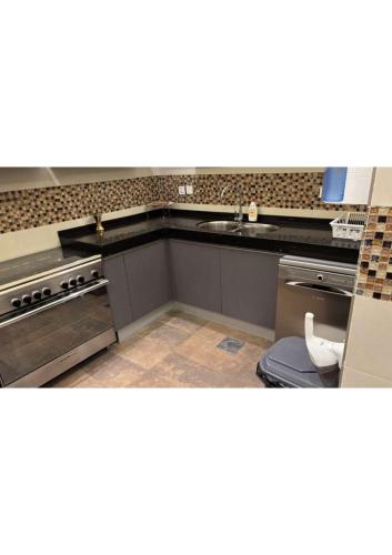 a kitchen with a sink and a stove at abha condo in Abha