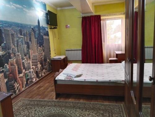 a bedroom with a bed and a view of a city at гостиница ЭРБИЛЬ in Taraz