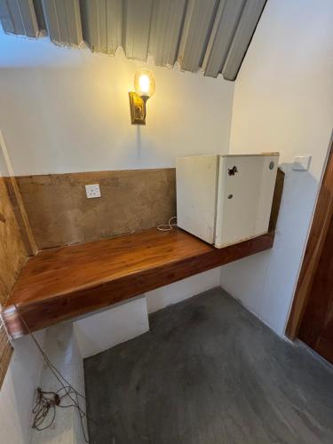 a room with a wooden counter with a box on it at Steps Garden Resort in Negombo