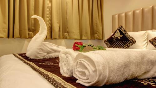 a hotel room with a bed with towels on it at Hotel Sapphire Inn Residency in Thane