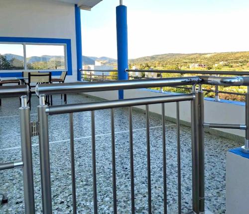 a metal railing in front of a building at Komi Blue in Kómi