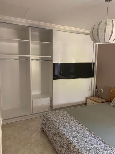 a bedroom with a bed and a wall with shelves at Eva House in Kanallaki