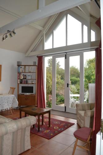 a living room with a couch and a table at The White Barn near Cambridge in Huntingdon