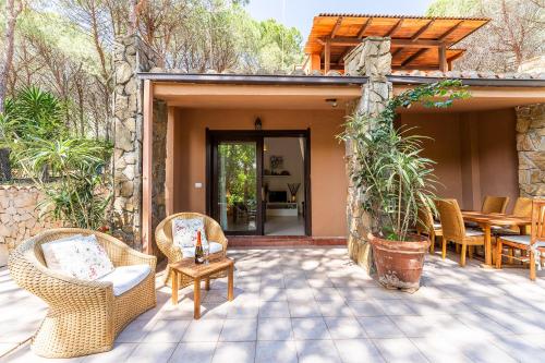 a patio with wicker chairs and a table at Coral House Premium, 200m to beach in Pinus Village