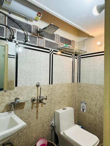 a bathroom with a toilet and a sink at Travellers Village-City Center Hertige Home in Jaipur