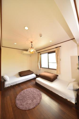 Ένα ή περισσότερα κρεβάτια σε δωμάτιο στο Beach side House SHELL kamakurahase