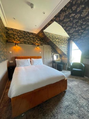 a bedroom with a large bed in a room at Falls of Lora Hotel in Oban