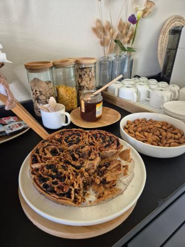 a table with a plate of food and bowls of nuts at Letizia B&B in Crotone