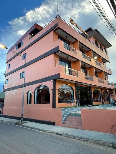 a pink building on the side of a street at The Morocco in Kaeng Krachan
