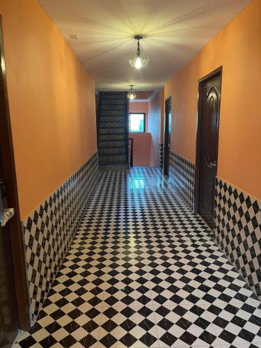 a hallway with a black and white checkered floor at The Morocco in Kaeng Krachan