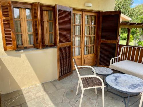 a patio with two chairs and a table and a couch at Reef in Afitos