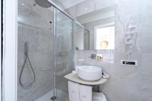 a bathroom with a shower and a toilet and a sink at Palazzo Ferraioli - Hotel & Wellness in Atrani
