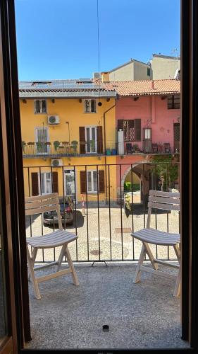 a balcony with two benches and a view of a building at Blueberry Villa - Historic Center in Luino