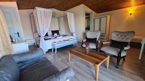 a living room with a bed and a couch and a table at Aphrodite Hotel Bozburun in Bozburun
