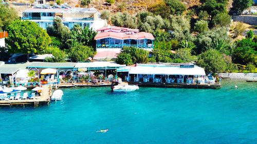 a resort on a lake with boats in the water at Aphrodite Hotel Bozburun in Bozburun
