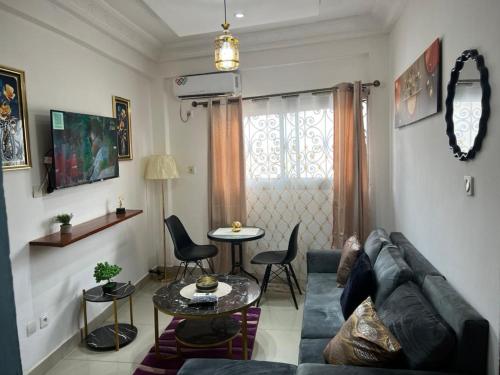 a living room with a couch and a table at Lekker Estate in Yaoundé