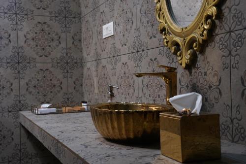 a bathroom with a wooden sink and a mirror at Room Suvira at Samava Farms Calicut in Kozhikode
